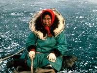 1965? Minnie Gray fishing through the ice for grayling. Wolf ruff with wolverine on the inside closest to the face.