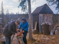 Late 1960s Gary and Dorene cutting caribou meat for drying.tif