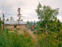 Joyce and Dan Denslow by a village cabin. Ambler, Alaska, 1964.