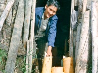 Mamie Cleveland with gathered birch bark for basket making.  Ambler, Alaska 1964.